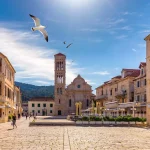 main square in old medieval town hvar with seagulls flying over hvar is one of most popular tourist destinations in croatia in summer central pjaca square of hvar town dalmatia croatia