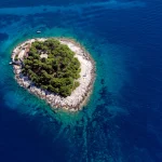 Little Island Galesnik in Adriatic Sea from air. The first in a row of all Pakleni islands, at the very entrance of the port of Hvar.